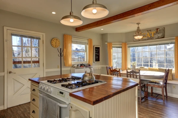 Breakfast nook with table, chairs, and bench seating in kitchen of a residential home.