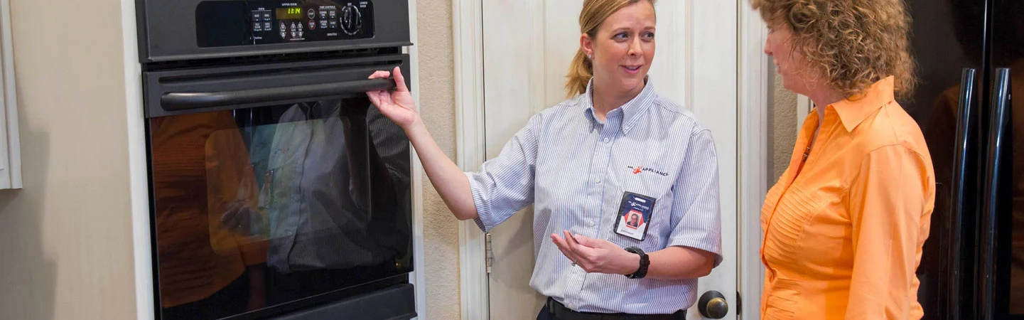 Mr. Appliance employee helping a customer with oven