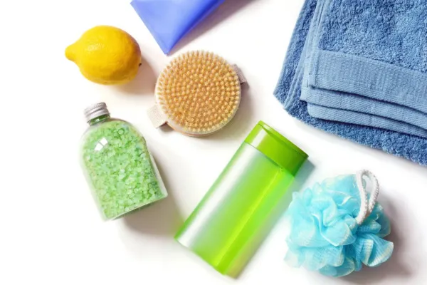 Bath products and a lemon on white surface