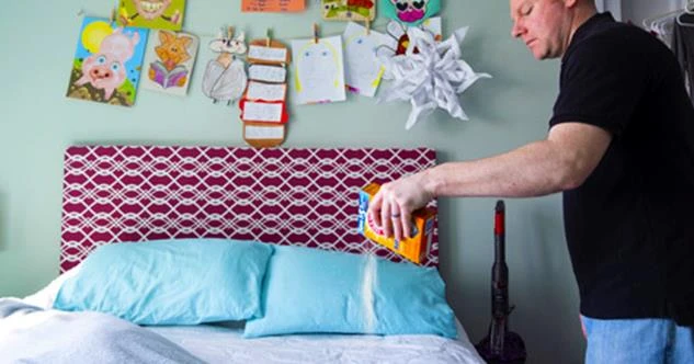 man sprinkling baking soda on child's bed