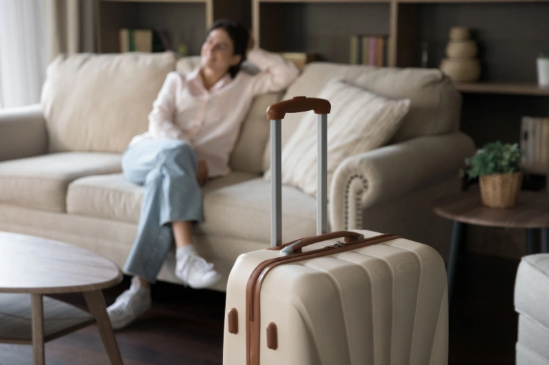 Woman sitting on couch in living room of a vacation rental home.