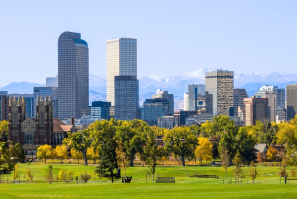 Denver skyline with Rocky Mountains in the background.