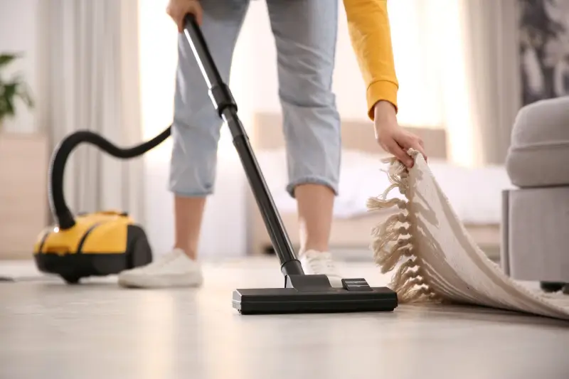 Woman vacuuming her living room floor