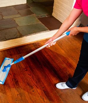 Molly Maid employee mopping floor