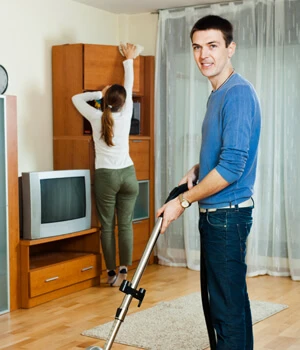 Woman dusting furniture