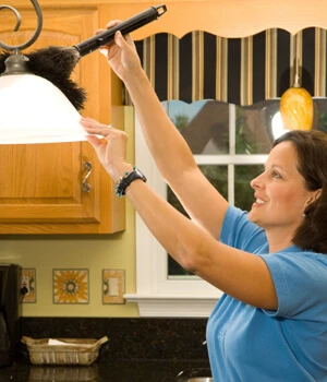 Woman dusting a light