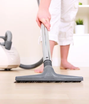 woman vacuuming the floor