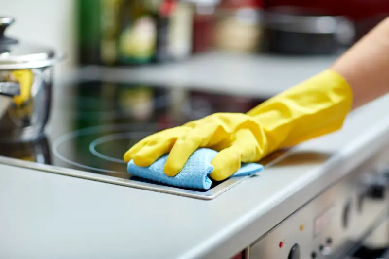 Person cleaning a stove